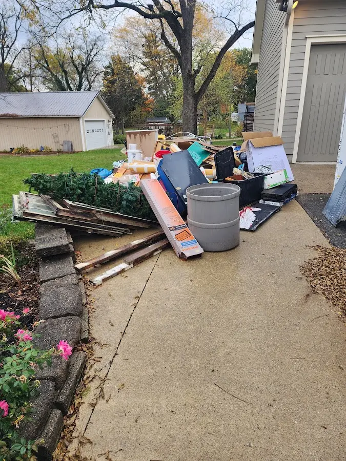 Dumpster being loaded with debris for Roofing Dumpster Rental in Orange Cove